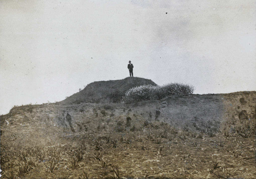 A man on a mound by a field