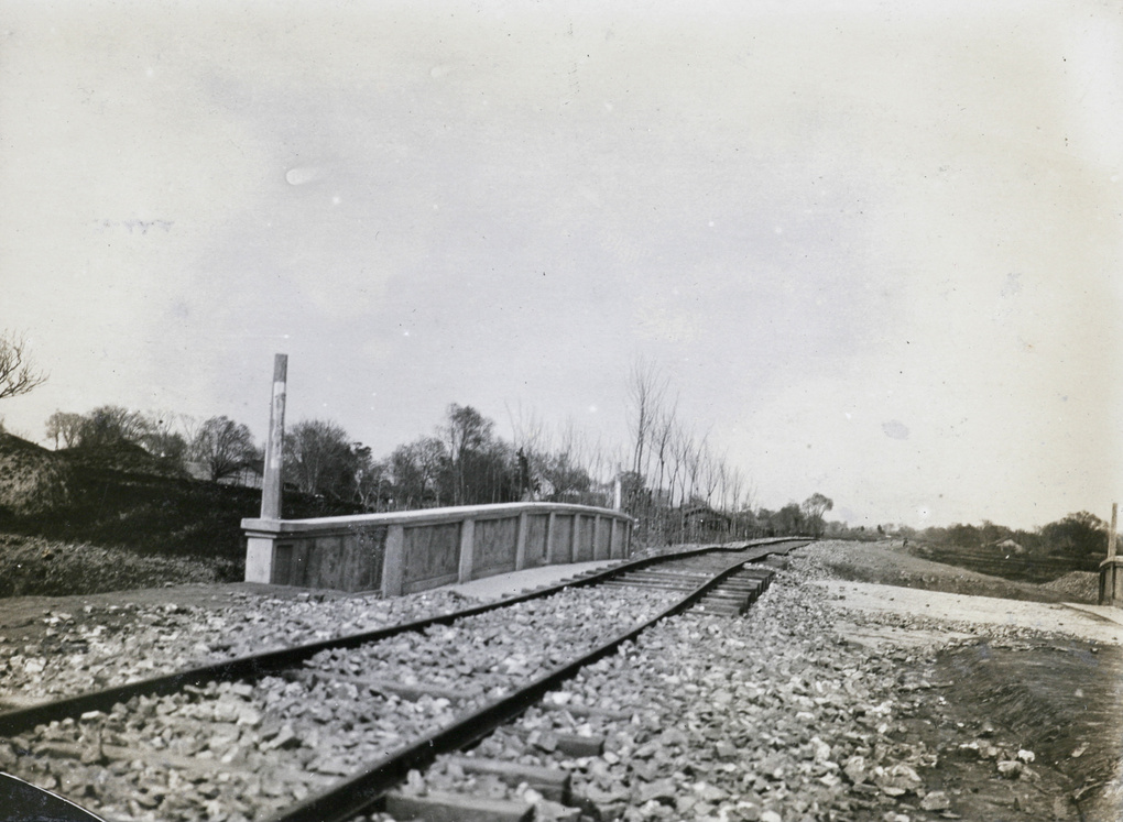 Bent railway tracks and a bridge