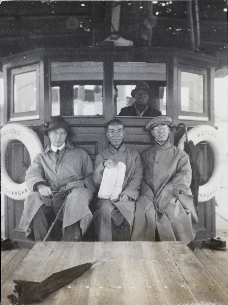 Three men on a boat (the ‘Watung’ ferryboat), and its helmsman, Shanghai