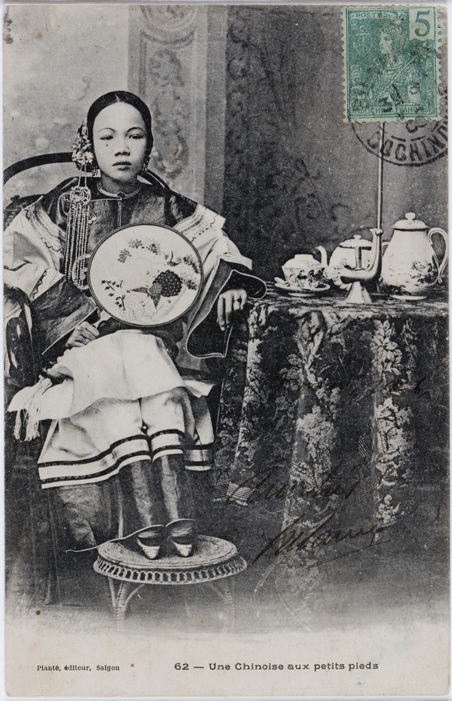 Young woman with bound feet (and with tea, and pipe)