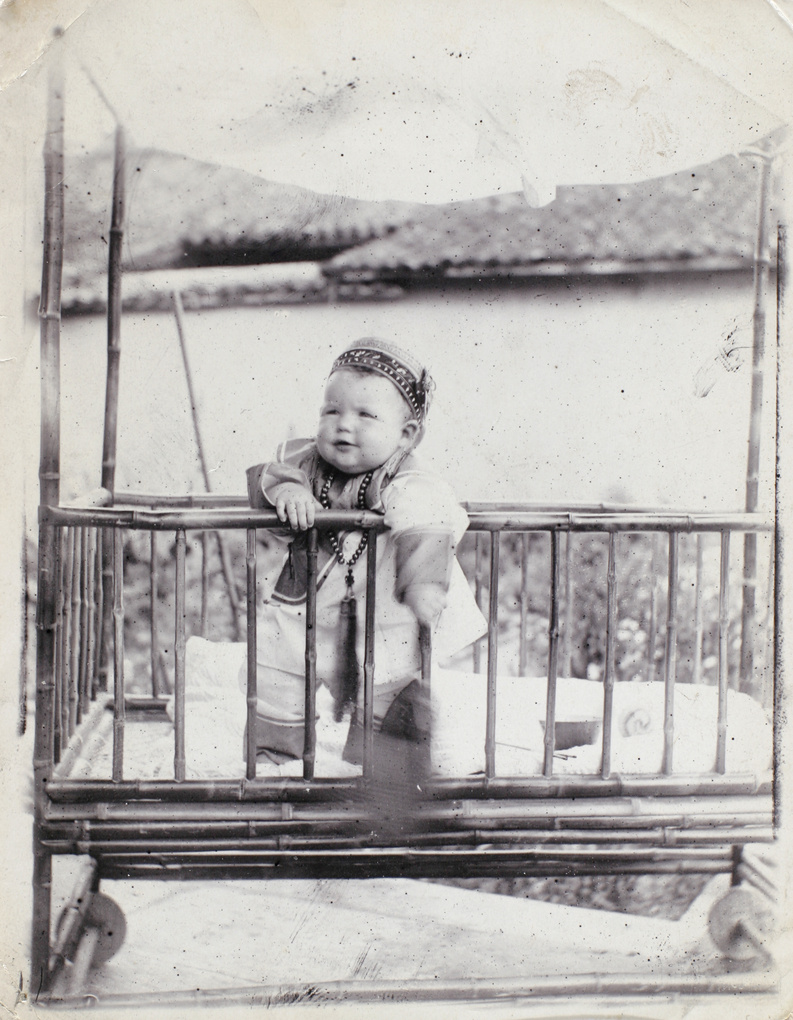 Dare Elliott aged nine months, in bamboo cot, 1909