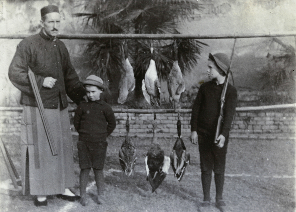 Dr C Elliott, Bill and Evans (Charles), with ducks in the garden at Paoning