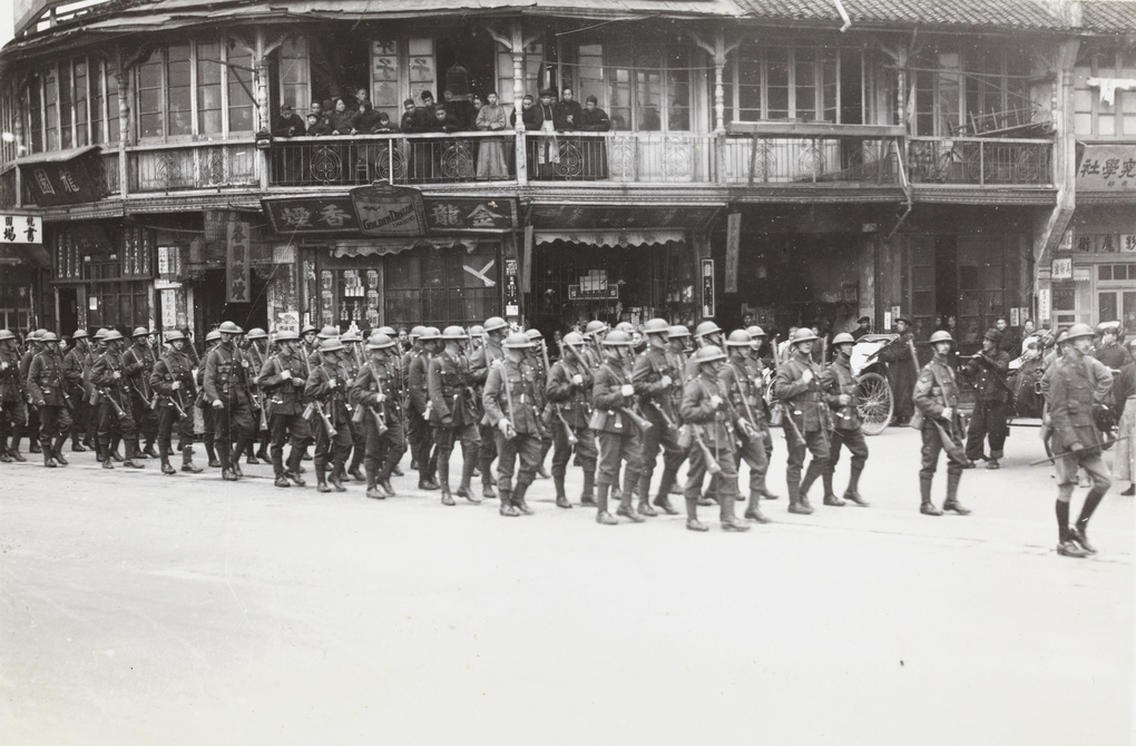 Watching British troops (Shanghai Defence Force) marching past shops, Shanghai
