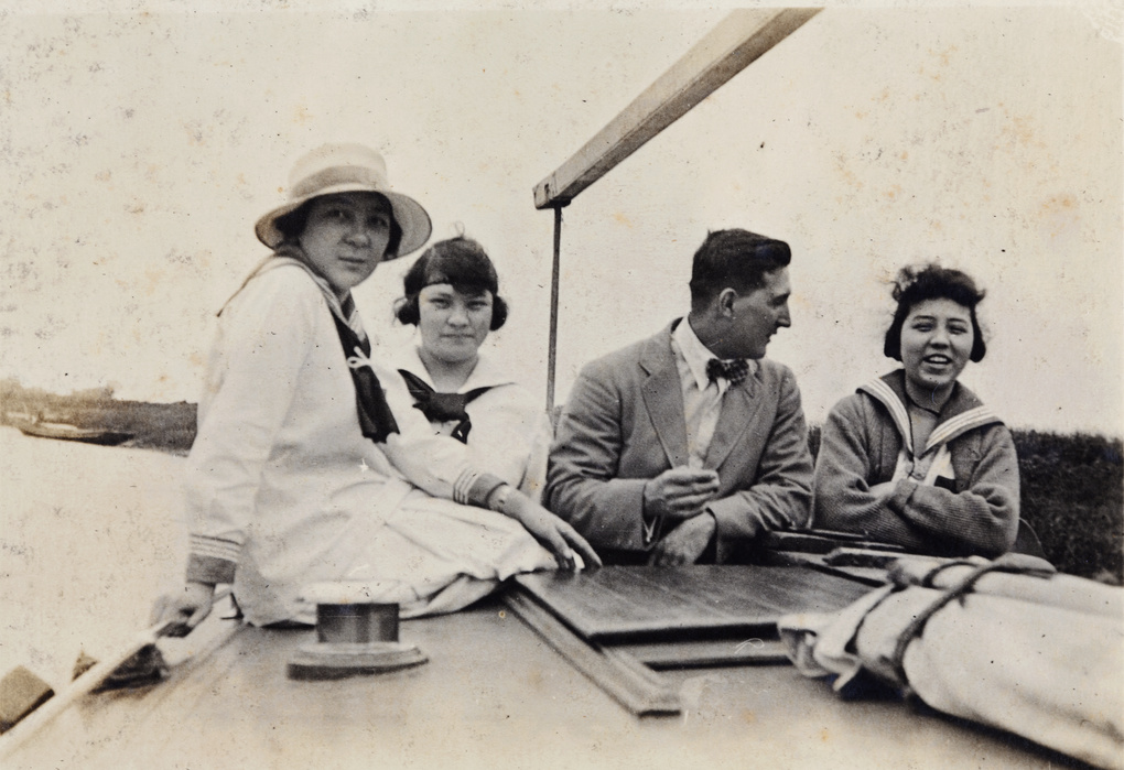 Charles Hutchinson with three young woman on an excursion boat