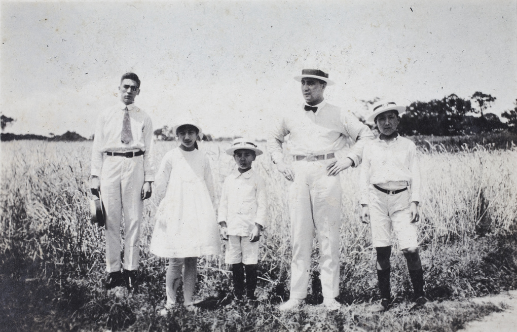 Bill, Maggie, Fred, Charles, and Dick Hutchinson standing at the edge of a field