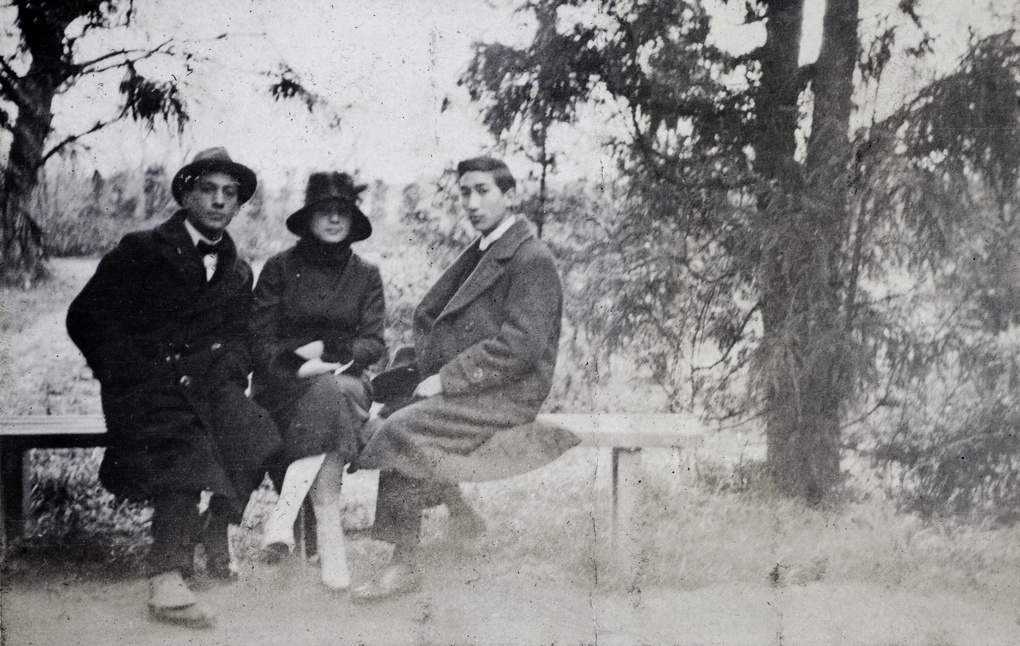 John Piry, a young woman and Tom Hutchinson sitting on a bench, Jessfield Park, Shanghai