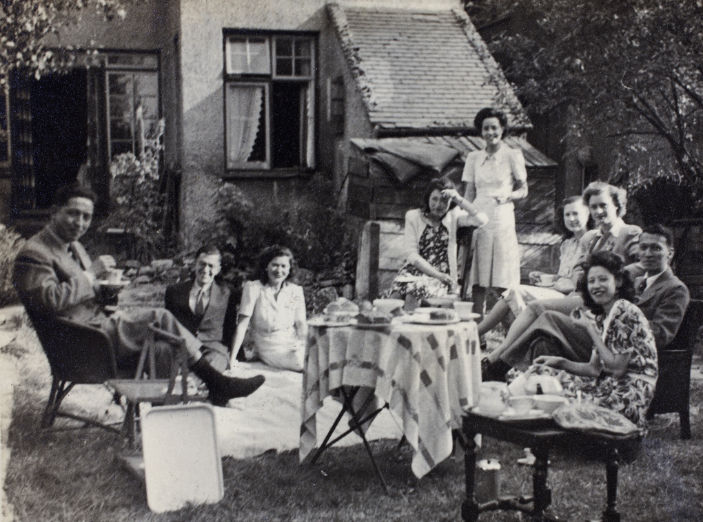 Gladys Hutchinson with a group of unidentified people at a garden tea party