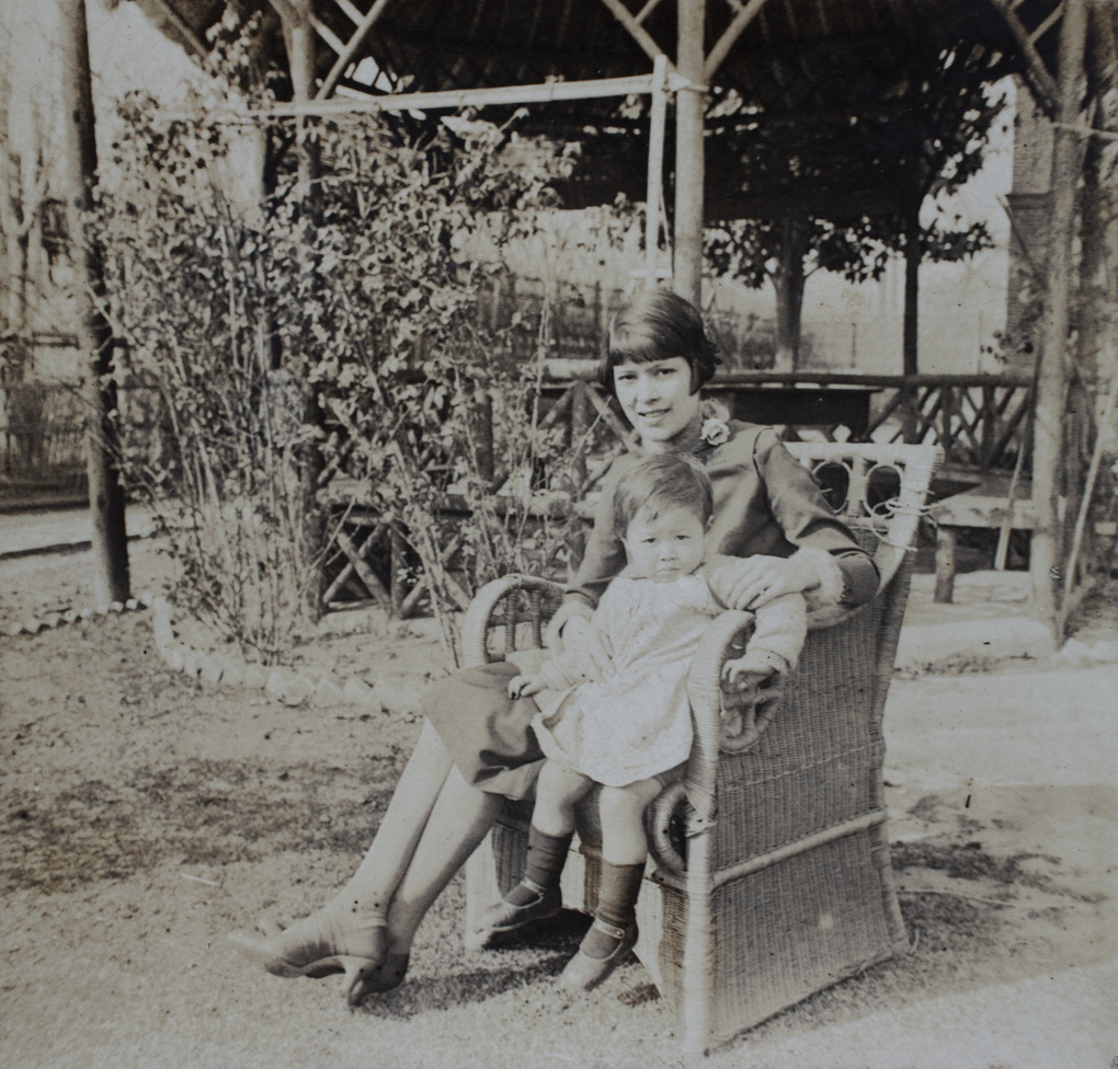 Mabel and Gladys Hutchinson sitting in a garden chair near the summer house, 35 Tongshan Road, Hongkou, Shanghai