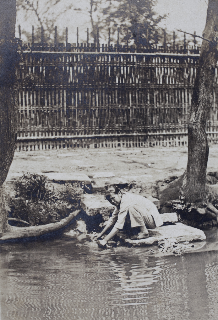 Woman washing laundry in a creek near Tongshan Road, Hongkou, Shanghai