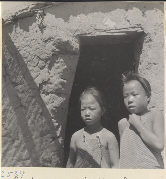 Children at the door of a house on the way to the Lost Tribe country.