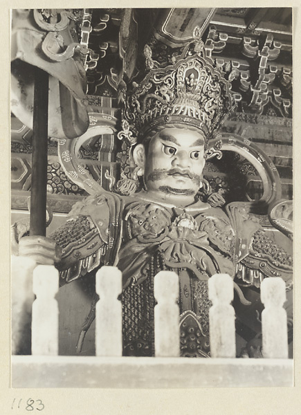 Detail of a celestial king holding an umbrella at Pu luo si