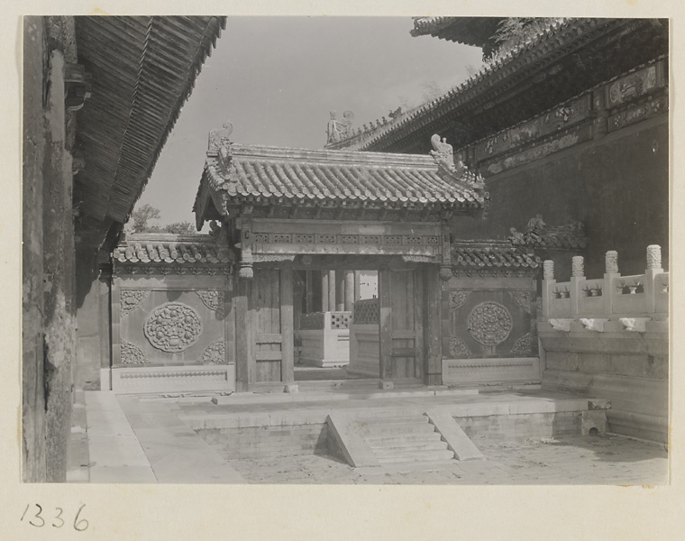 Gate with glazed-tile relief work on flanking walls in the Forbidden City