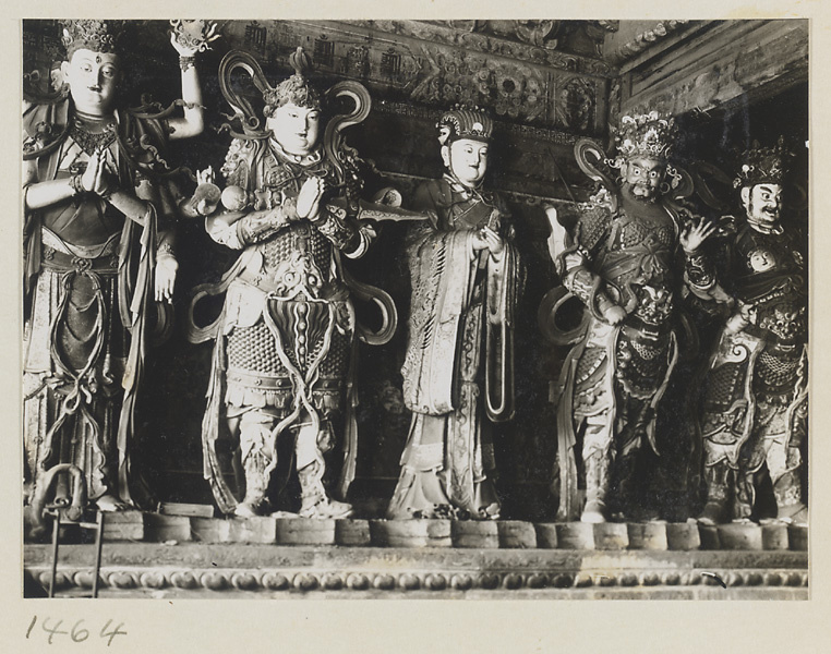 Statues of a multi-armed Bodhisattva, a shrine figure holding a sceptre, an official holding tablets, and two celestial kings at Da Fo si