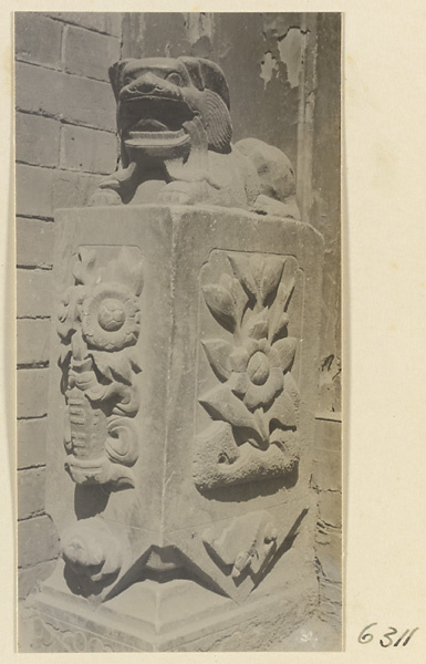 Carved door stone with floral motifs and animal finial