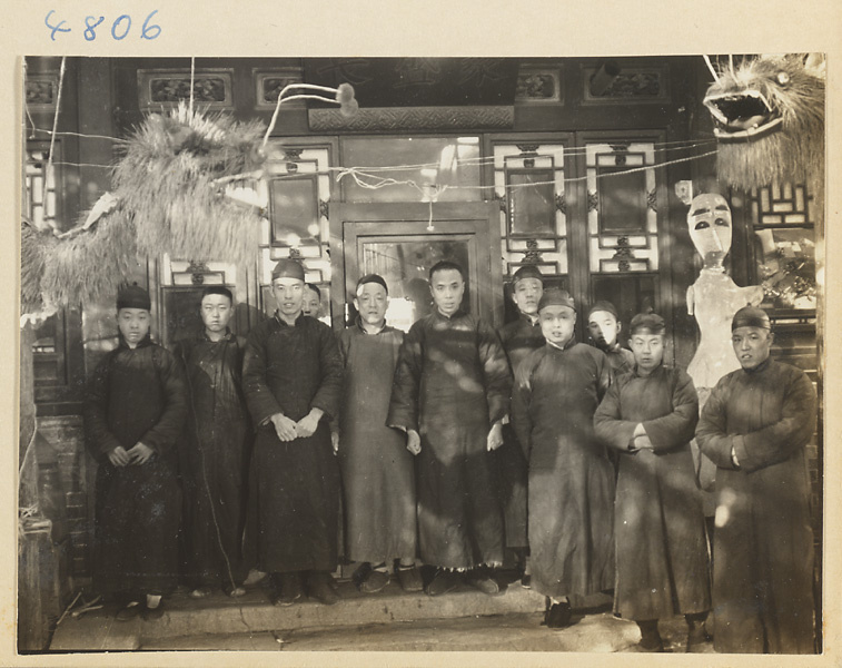 Interior of an ice lantern shop showing a group of men, dragon figures, and an ice lantern in the form of a human figure