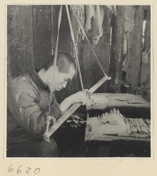Man finishing a comb in a horn-comb workshop
