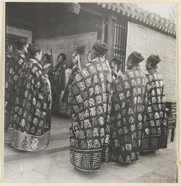 Taoist priests wearing ritual robes at a blessing ceremony or funeral