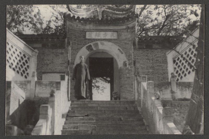Man at top of stairs leading to gong bei of Bu Hading
