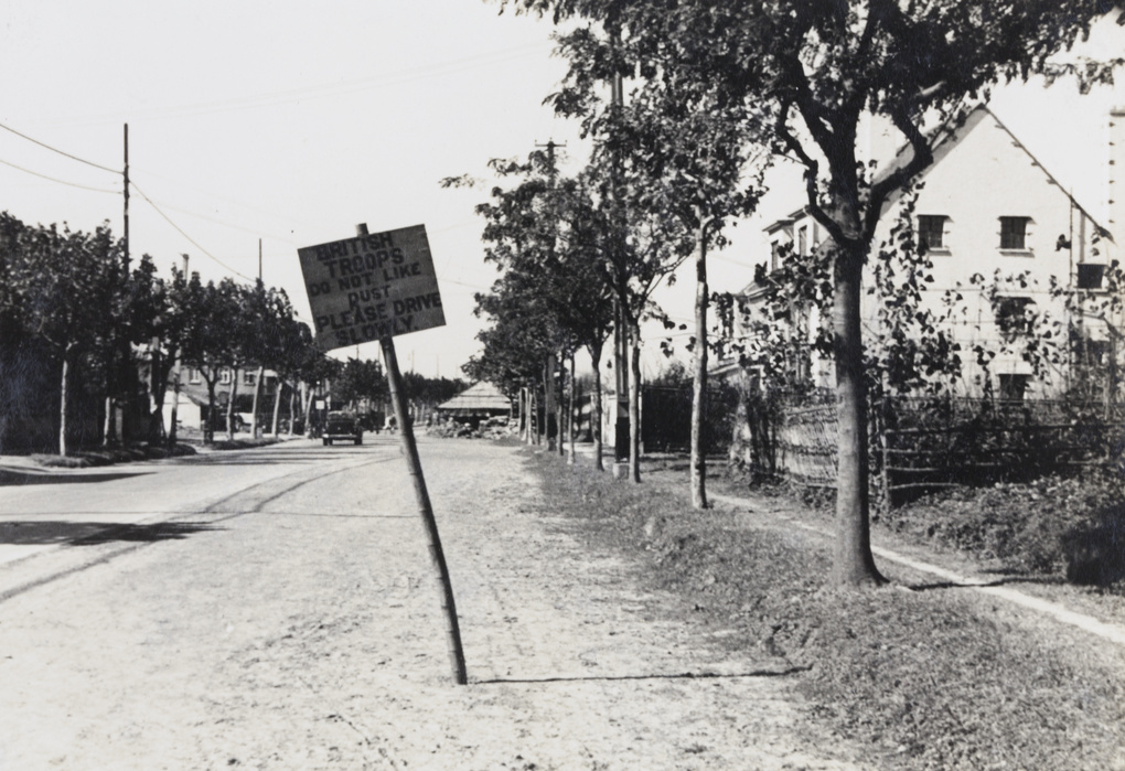 A road sign near a checkpoint: ‘British troops do not like dust Please drive slowly’, Shanghai, 1937