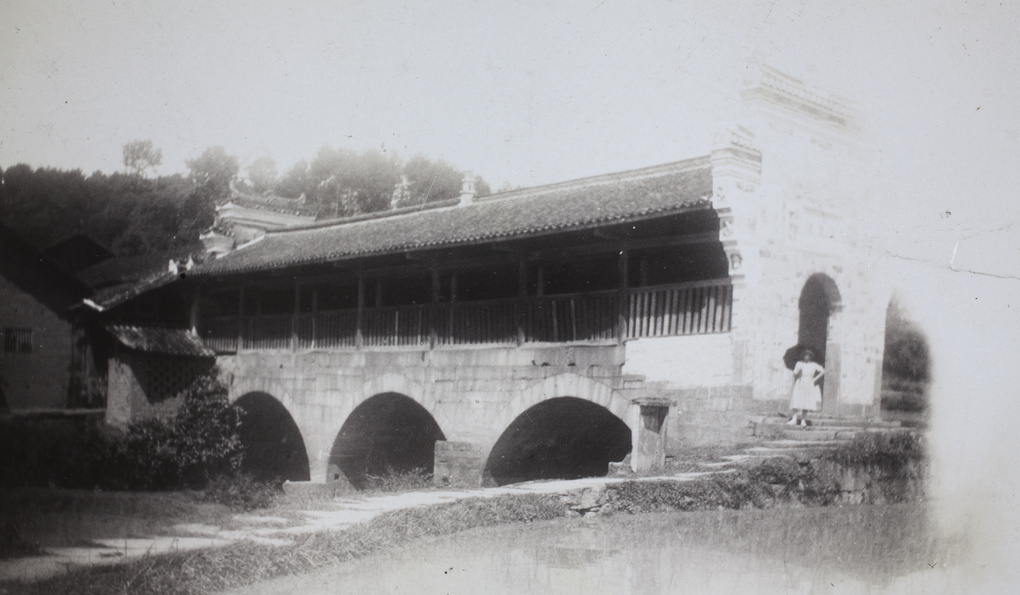 May Stanfield beside a covered bridge, Shaoyang