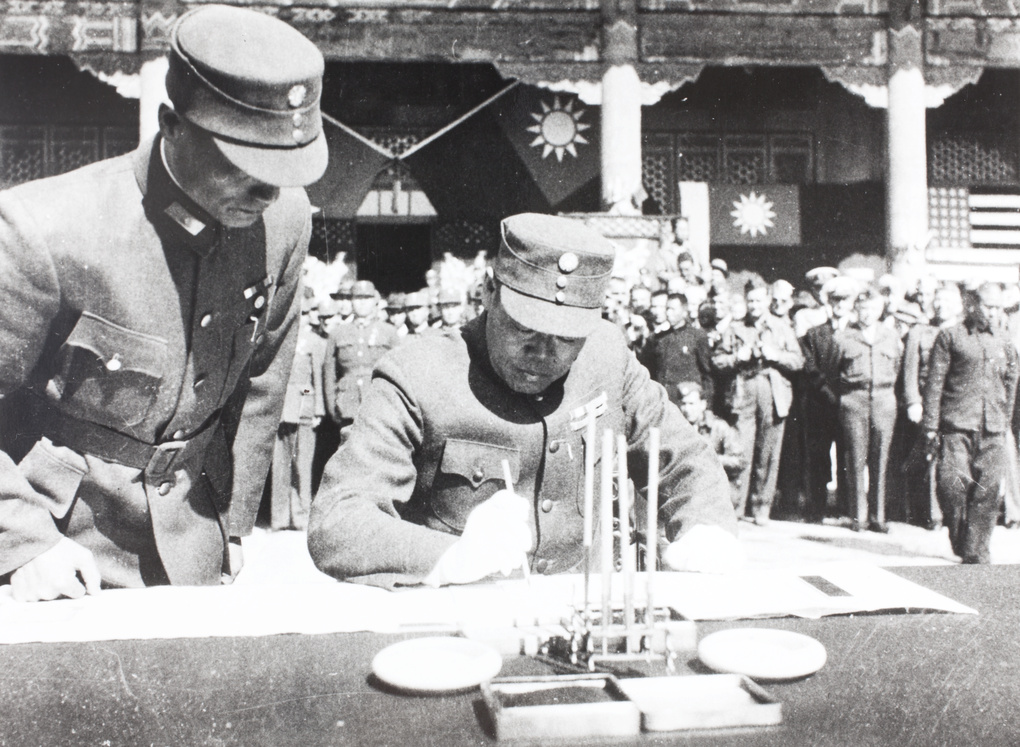 General Sun Lianzhong signing Japanese surrender documents, Peking