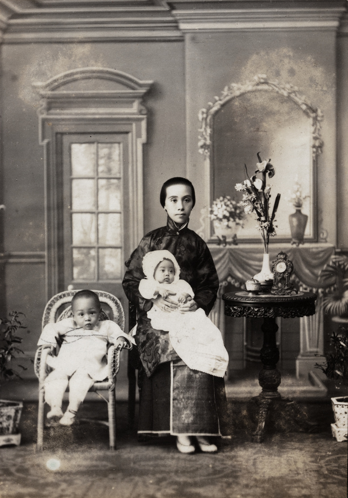 Studio portrait of a woman with two children