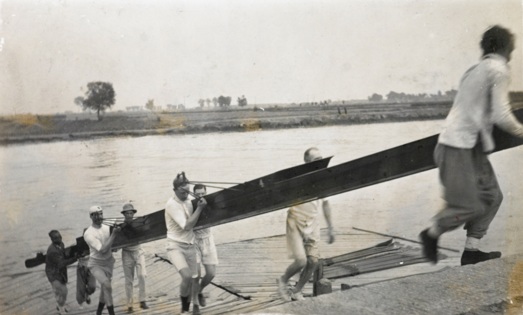 Carrying a rowing boat off a landing stage