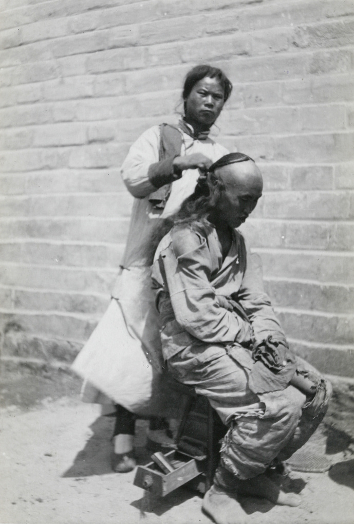 Itinerant barber plaiting a customer's queue, Peking