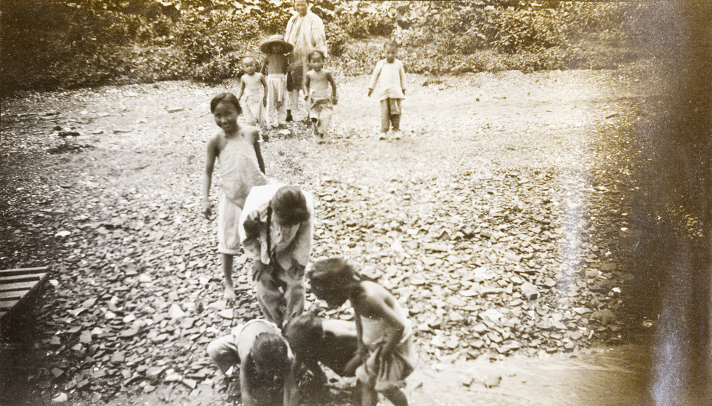 Children looking for coins thrown from a boat