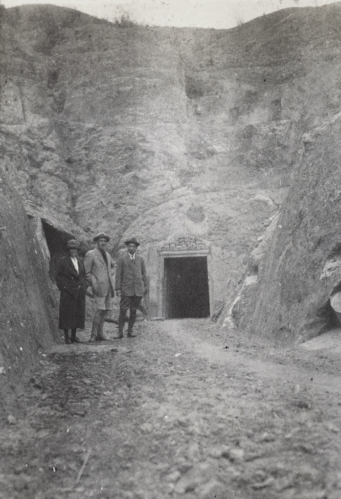 Three people by the entrance of the no 1 tunnel, China Mining & Metal Company Ltd., Tien Sze Liang