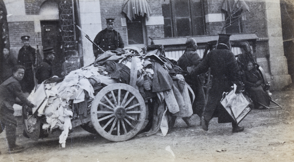 A cartload of loot and an arrested man, outside a police station, Tianjin (Peking Mutiny 1912)