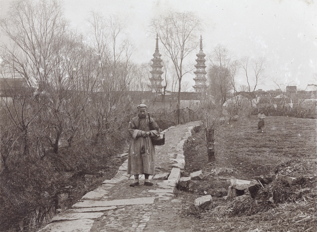 A man on a path near the Twin Pagodas at Luohanyuan Temple, Soochow (苏州双塔）