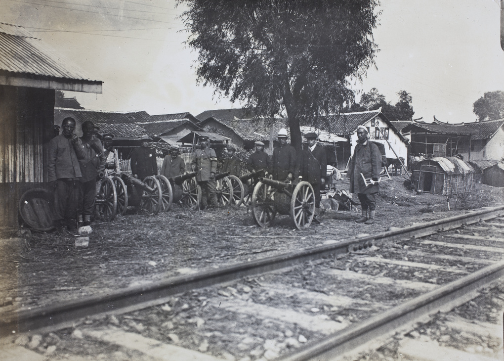 Revolutionary soldiers and field guns beside railway track
