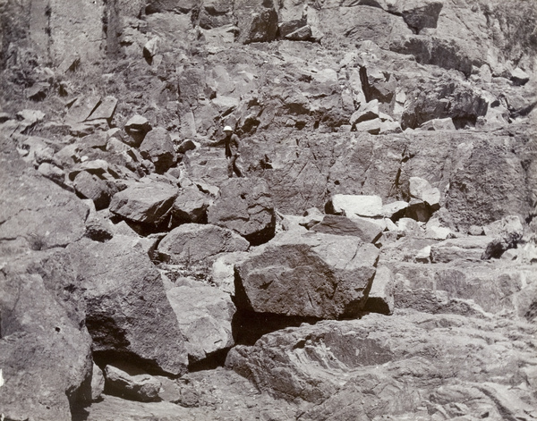 Man on rocks below Shaweishan Lighthouse, Tsungming Island