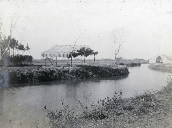 Riverside boat shelter and bridge