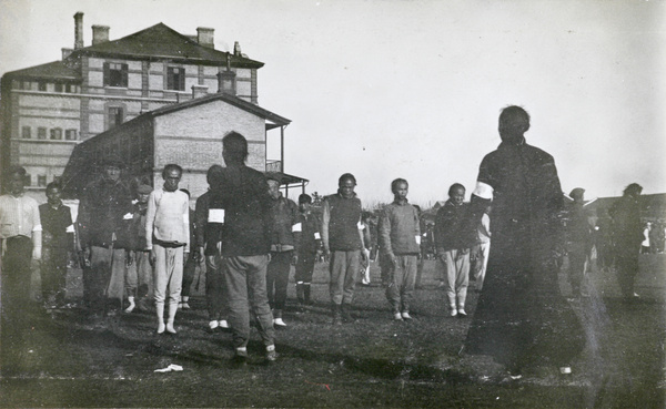 Line up of men with white armbands