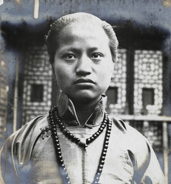 A young woman with a beaded necklace