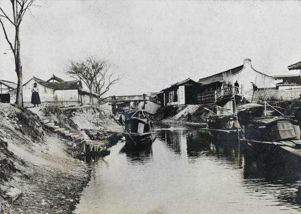 A waterway with boats and houses
