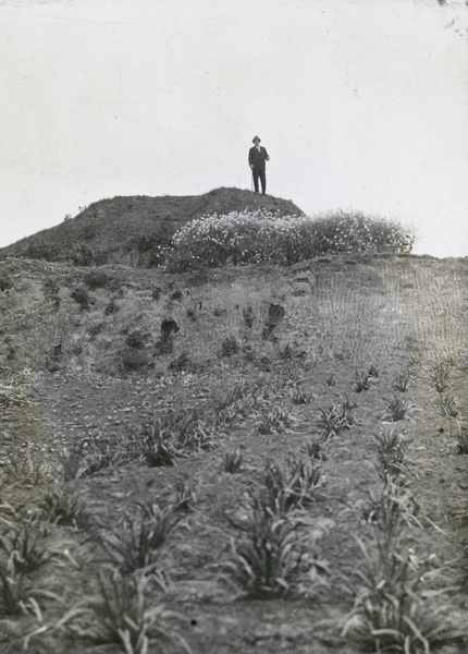 A man on a mound by a field