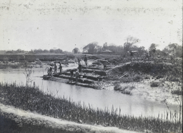 Working on an embankment at a river confluence