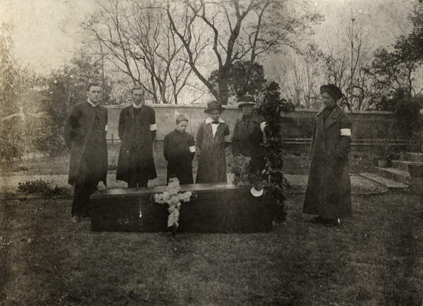 Mourners with coffin