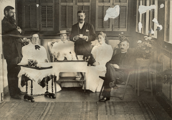 Three couples having tea