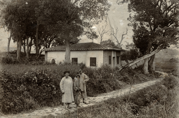 Three people and a building