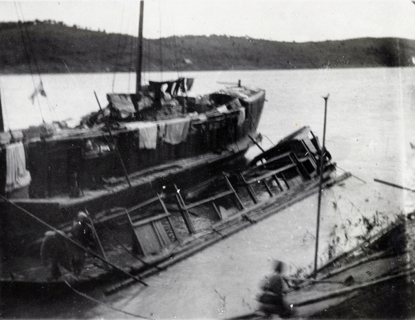 Drying laundry on a boat beside the wreck of the 'Archdeacon Byrde', Cassia River