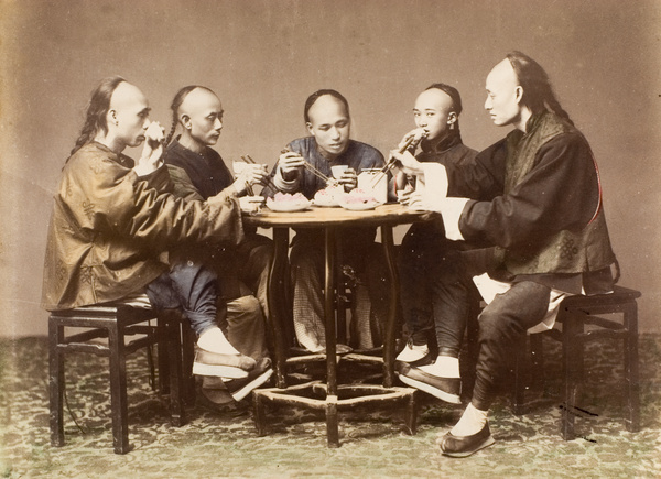 Five men having a meal