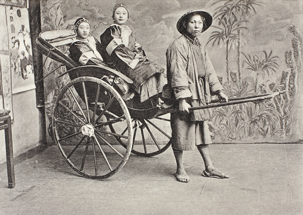 Rickshaw in a photographer's studio, with female passengers