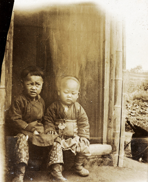 Children sitting on a doorstep