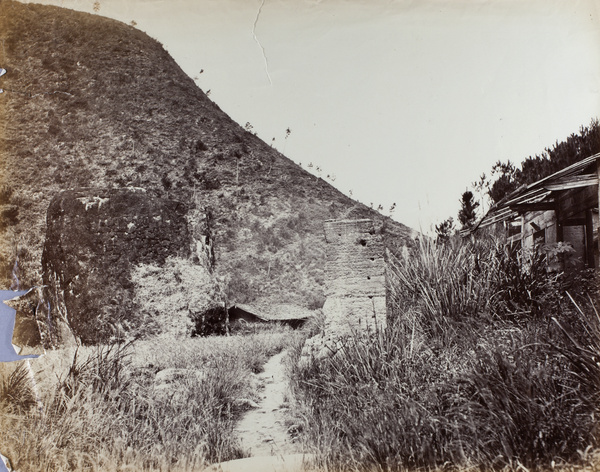 Path, pillar and houses