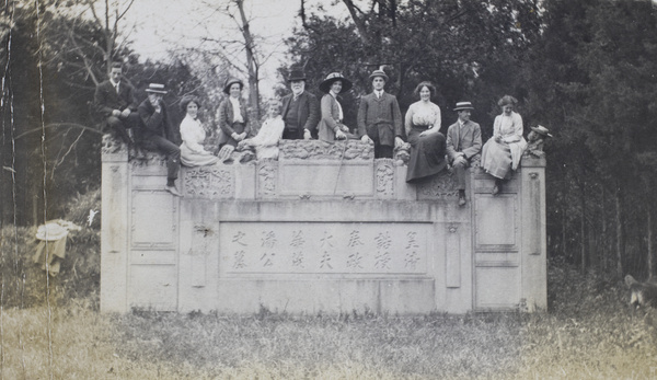 Timothy Richard with daughters and family, posed on a monument