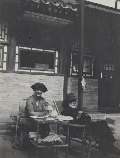 Guy Hillier knitting, with his wife Ella and their cat Carpentier, Balizhuang, near Beijing